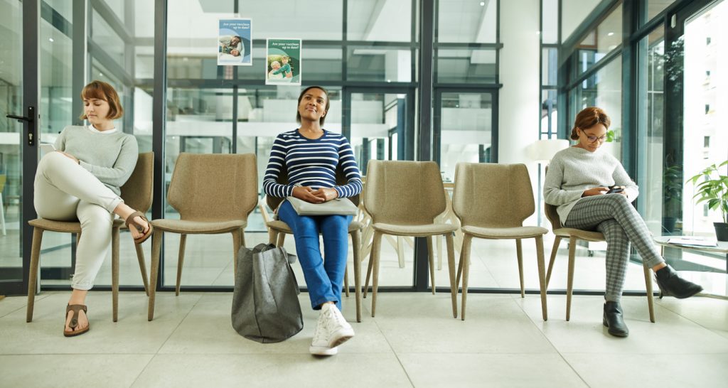 group of young women sitting in the waiting room of a clinic